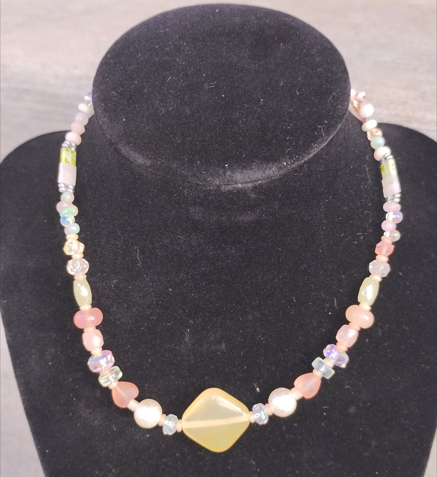 Light orange/yellow/pink beaded necklace with heart and pearl beads