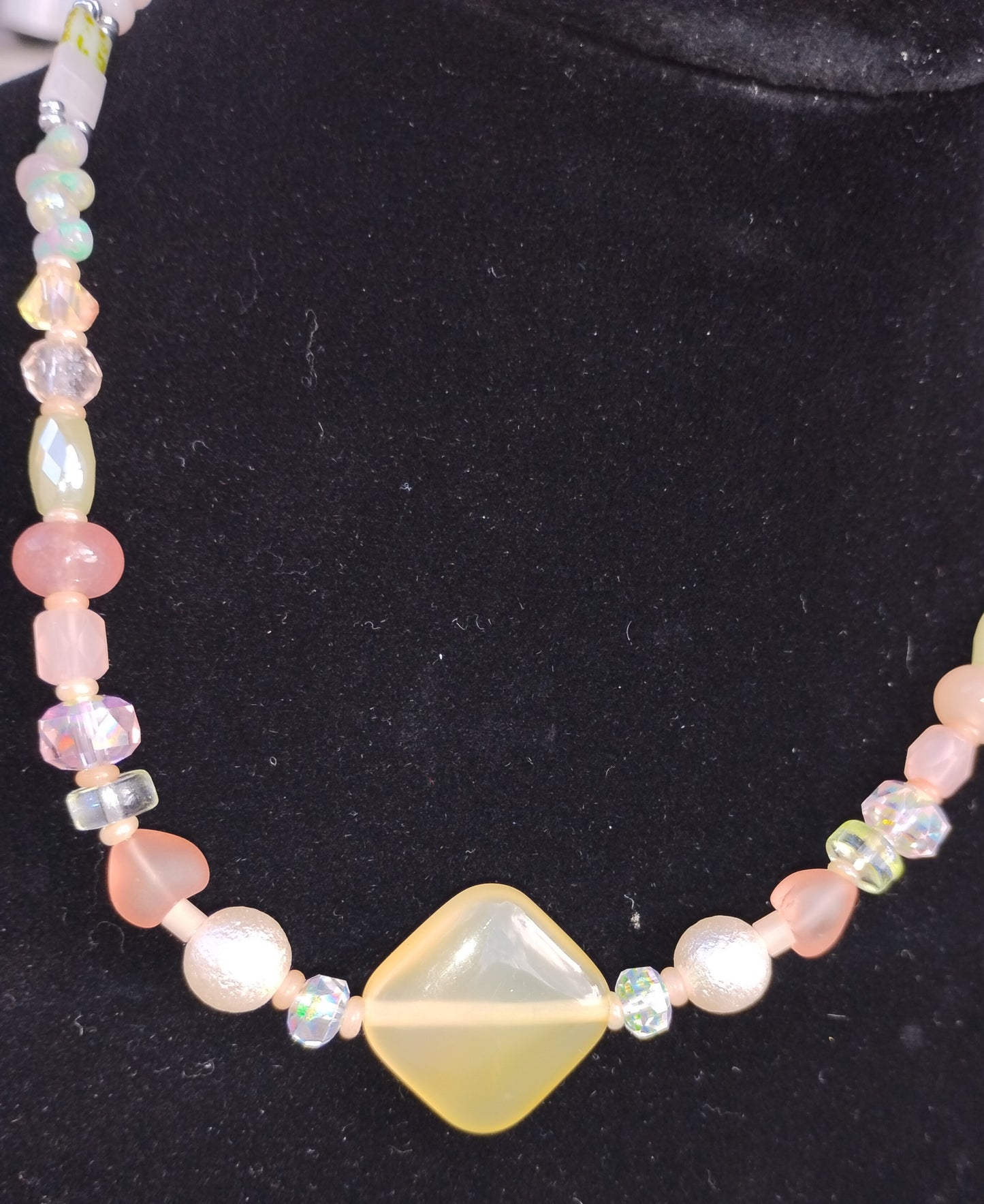 Light orange/yellow/pink beaded necklace with heart and pearl beads